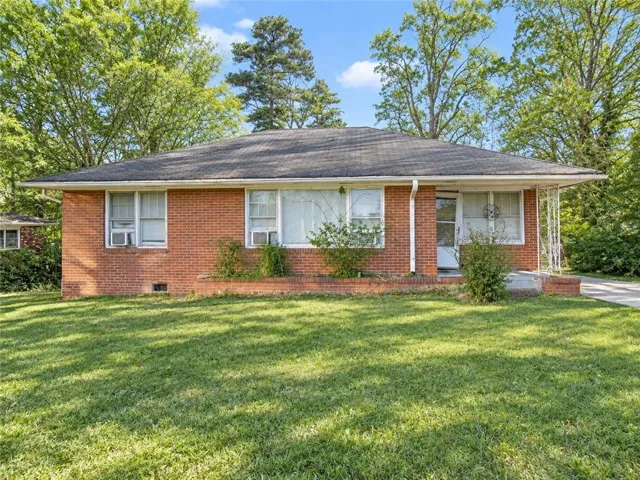 Brick exterior with a covered front entry and a well-maintained lawn