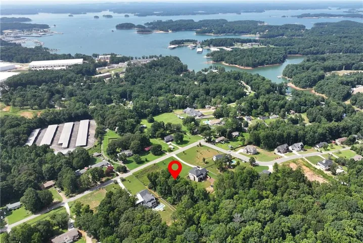 Aerial view of a residential area featuring a prominent body of water with numerous islands and boat docks