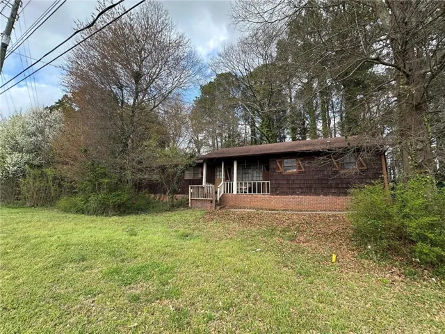 View of front of property with a front lawn and a deck