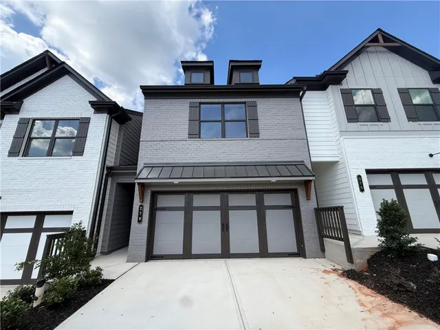 Contemporary multi-level exterior with brick and siding facade