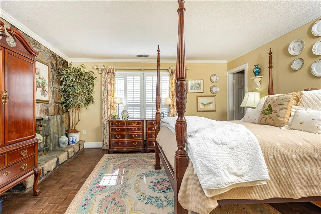 Handsome primary suite complete with wood-burning, granite fireplace.