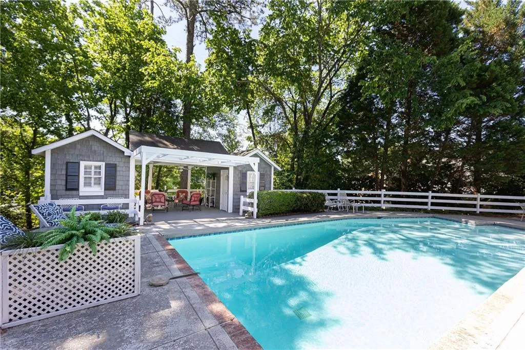 Convenient pool house with a half bath and lots of storage.