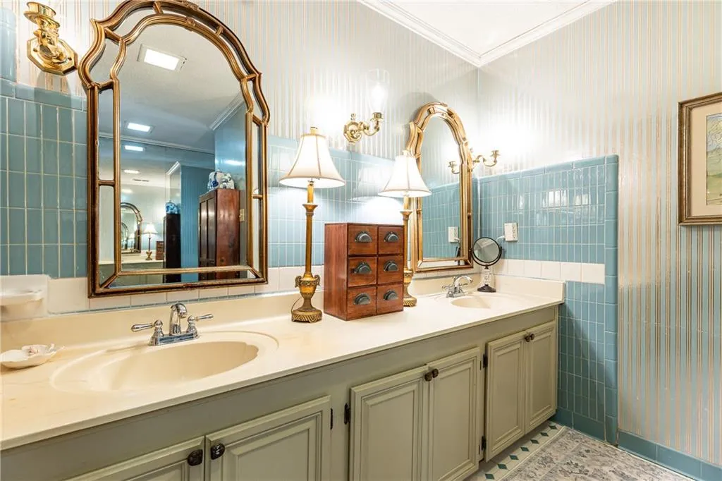 Spacious primary bath features double vanities and tub/shower combo.