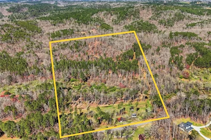 Aerial view of property and surrounding area with property parcel outlined