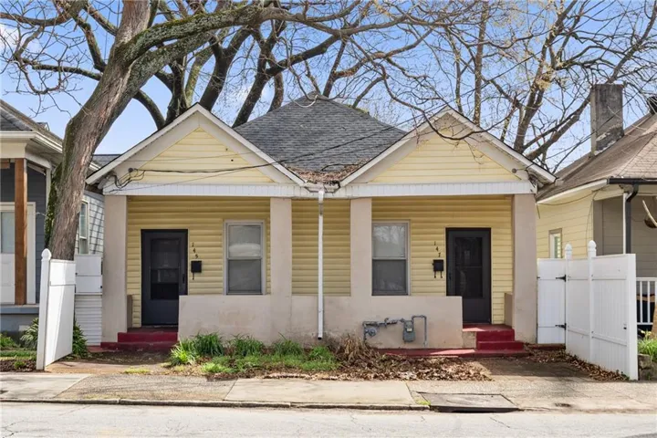 Yellow siding exterior with white trim