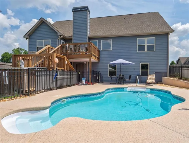 rear of home with pool