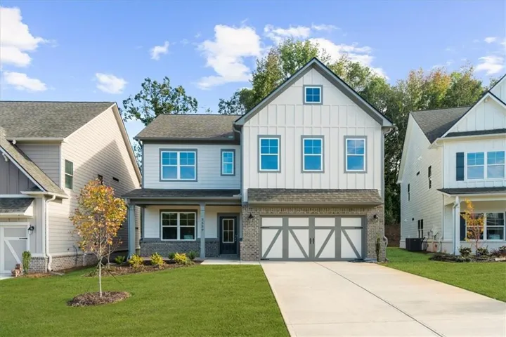 Two-story home with a light gray and white exterior