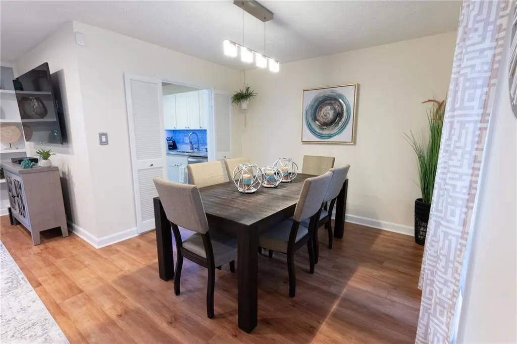 Dining area with light wood-type flooring dimmable light fixture