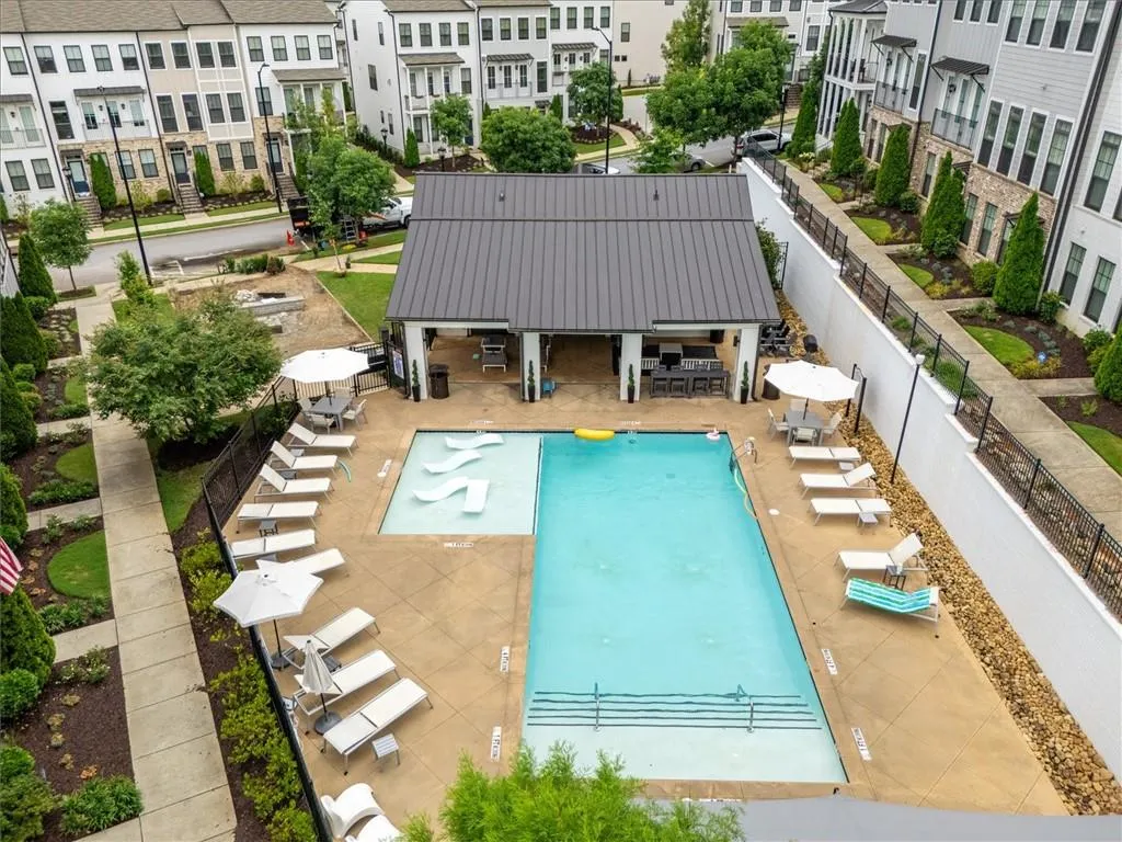 Community pool featuring a patio and outdoor dining space