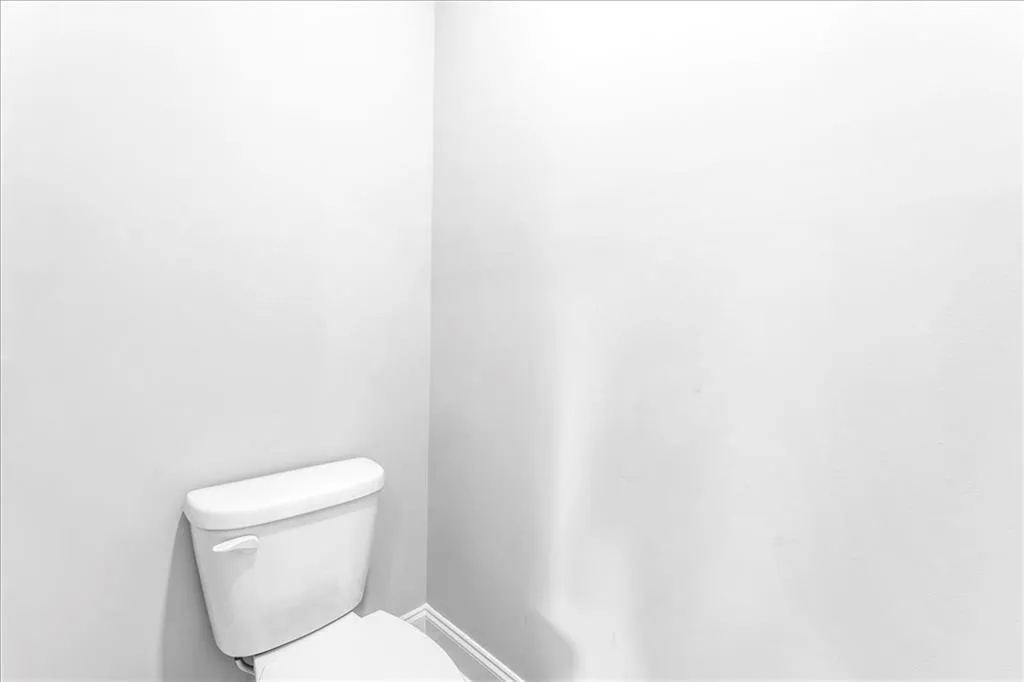 Half bath with toilet and baseboards