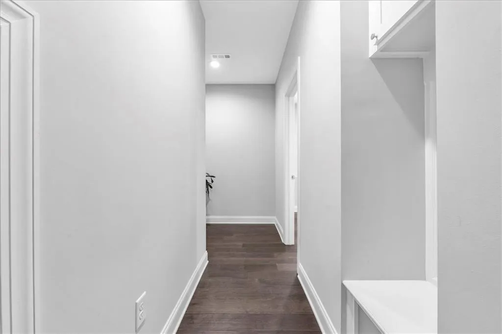 Corridor featuring dark wood-style floors and recessed lighting
