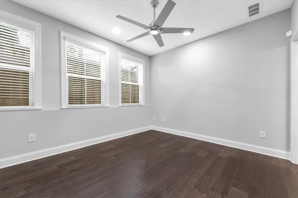 Spare room featuring dark wood finished floors, recessed lighting, and a ceiling fan