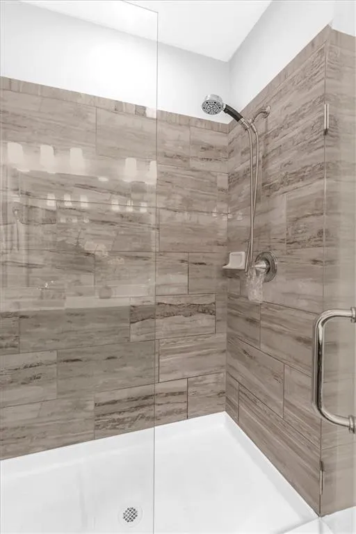 Full bathroom with a shower stall