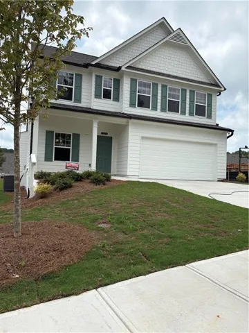 Two-story residence featuring white siding and coordinating shutters