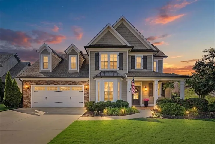 Elegant two-story Colonial with multiple gabled rooflines and stone-and-siding exterior