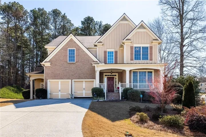 Welcome home to this striking Craftsman-style home featuring an attached garage, covered front porch, brick and board  batten siding, located in sought after Hamilton Mill