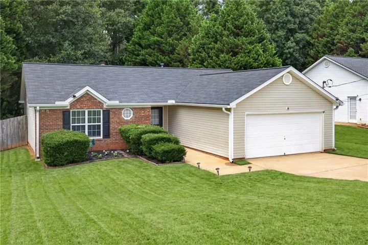 Brick and siding exterior with a two-car garage