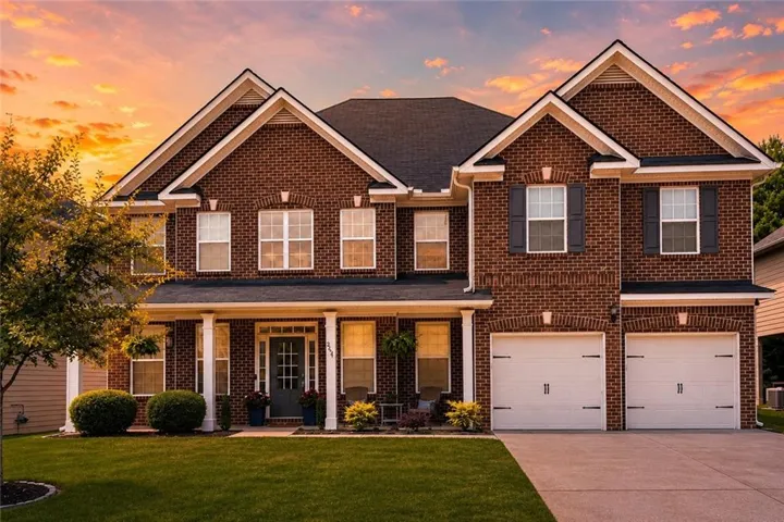 Brick exterior with multiple gables and a dark shingle roof
