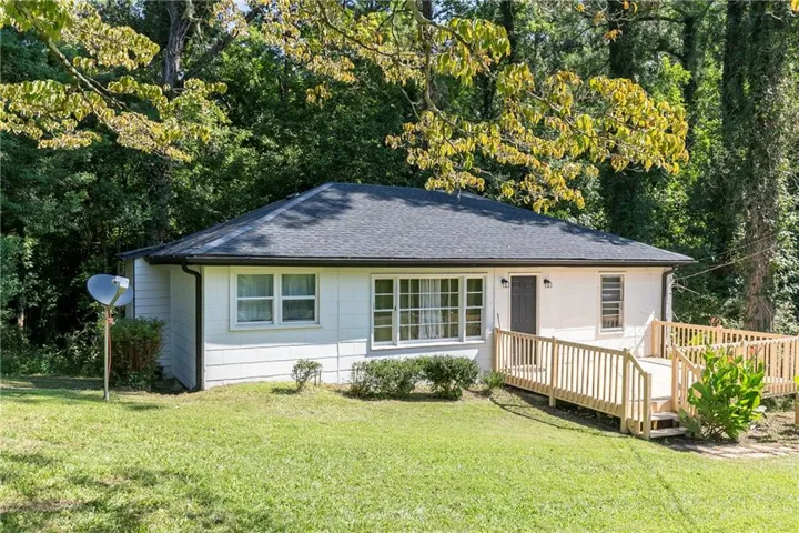 White exterior siding with a dark asphalt shingle roof