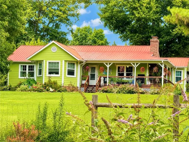 Lime green siding with a vibrant red metal roof