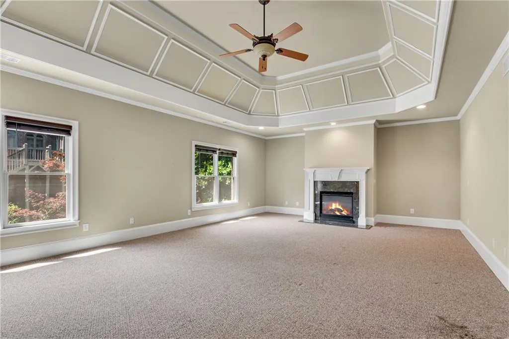 Oversized primary suite with fireplace and trey ceiling