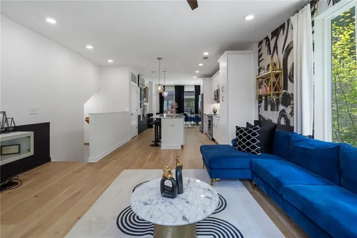 Living area featuring light wood-style flooring and recessed lighting