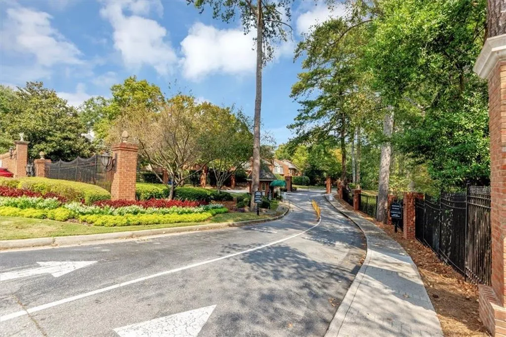 View of asphalt road featuring curbs and sidewalks