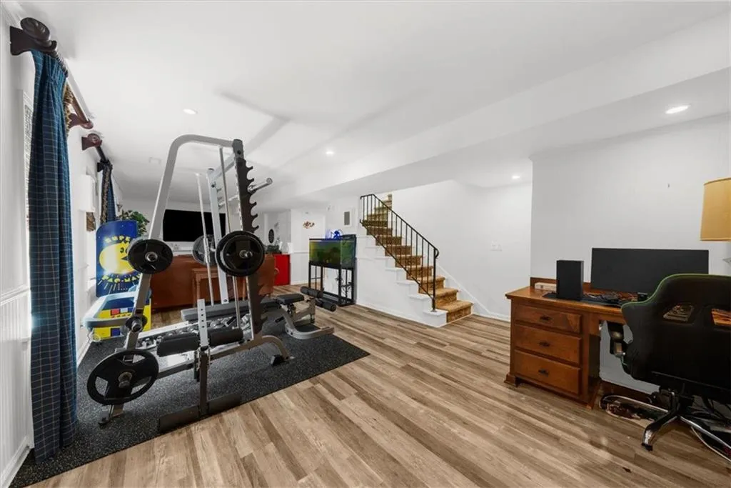 Office space with light wood finished floors and recessed lighting
