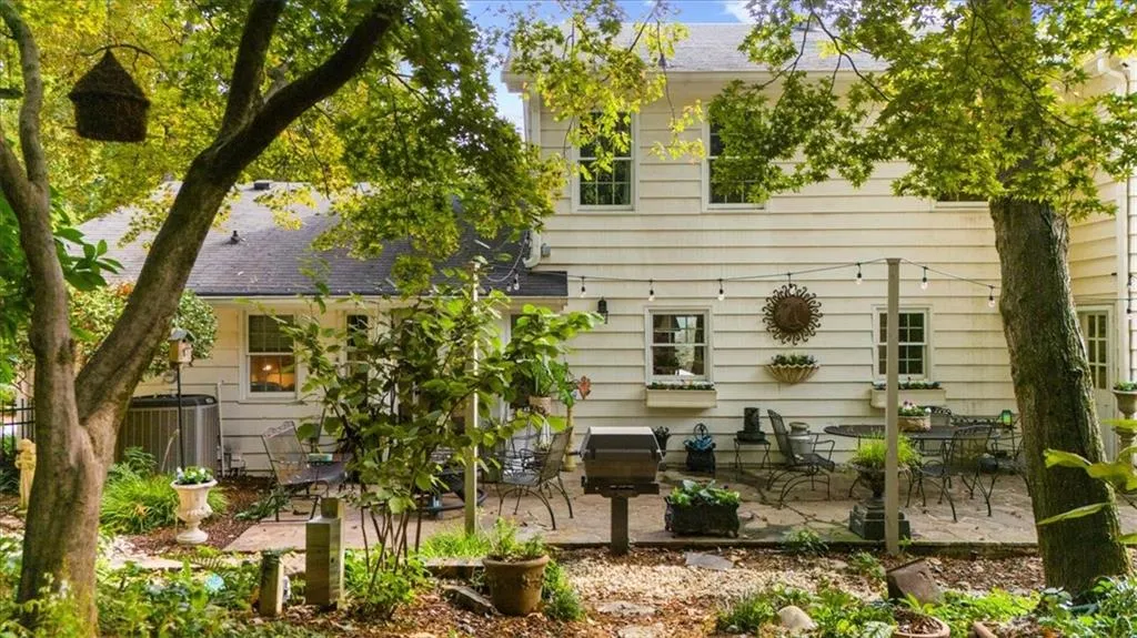 Back of property featuring a patio and roof with shingles