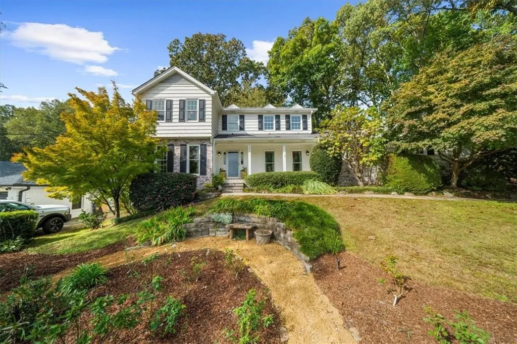 Traditional-style home with covered porch and a front yard