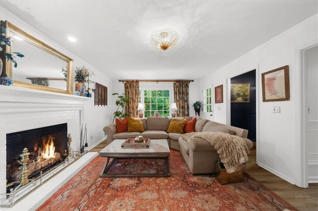Living area featuring wood finished floors and a fireplace