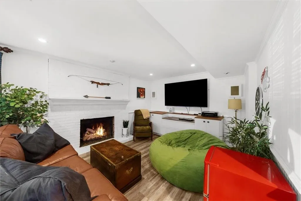 Living area with wood finished floors, recessed lighting, and a fireplace