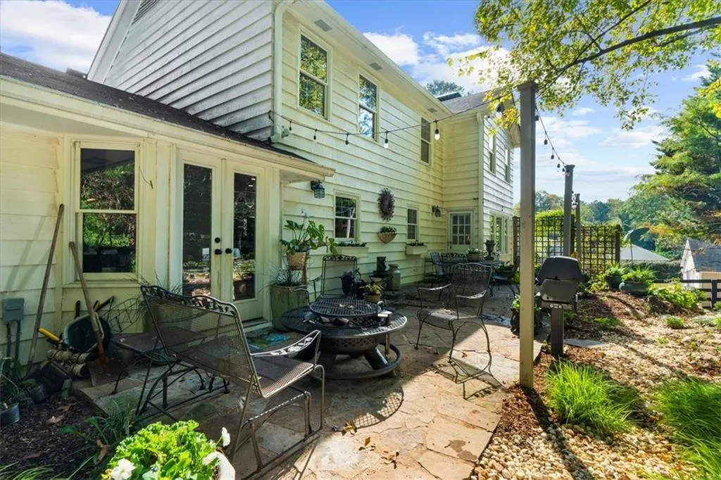 Rear view of house with a fire pit, a patio area, and french doors