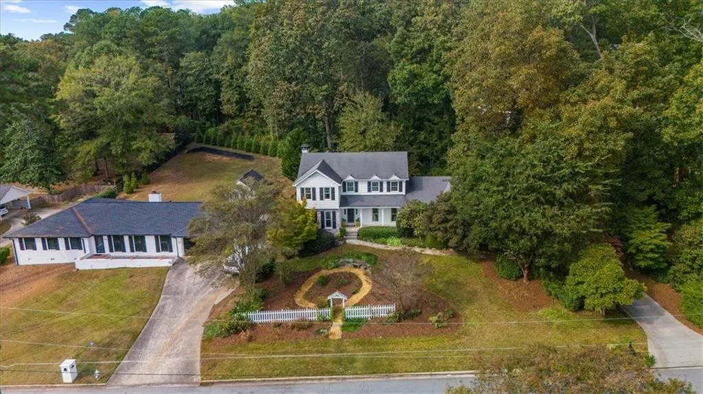 View of subject property featuring a forest