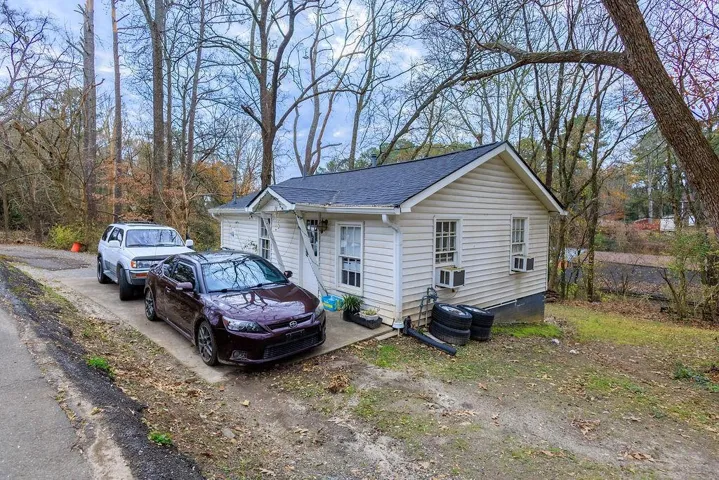 View of side of home featuring roof with shingles