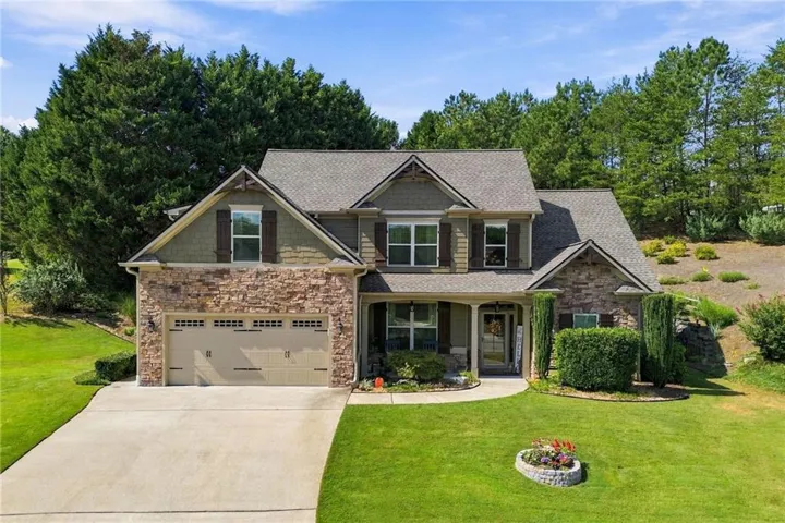 Stone and siding exterior with a gabled roof