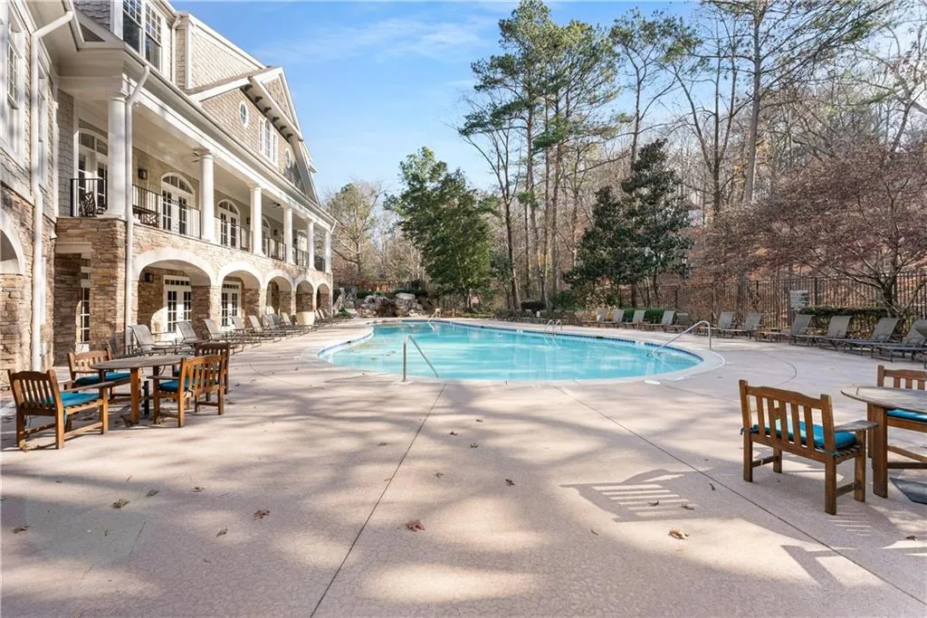 A view of the waterfall that sits between the upper and lower pools. Lots of pool decking, both covered and uncovered to sit and enjoy this space. The trees on the right border to a national forest that will never be touched.