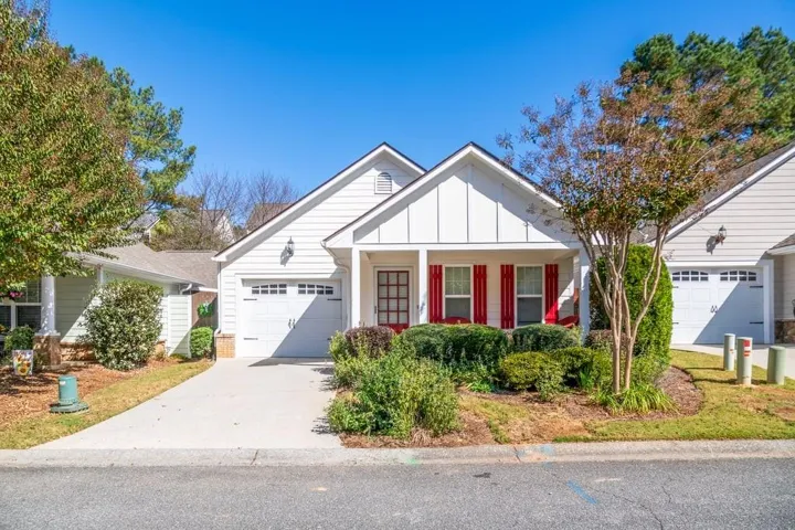 Charming ranch style home! NEW carpet, upgraded LVP flooring & carpet!  Concrete sided exterior with red shutters and a covered front porch. Lawn maintenance included in monthly fee.