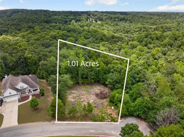 1.01-acre wooded lot featuring cleared sections and mature trees