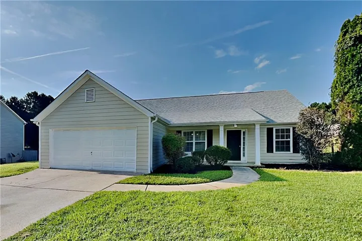 Light-colored siding exterior with a single-car garage and dark shutters