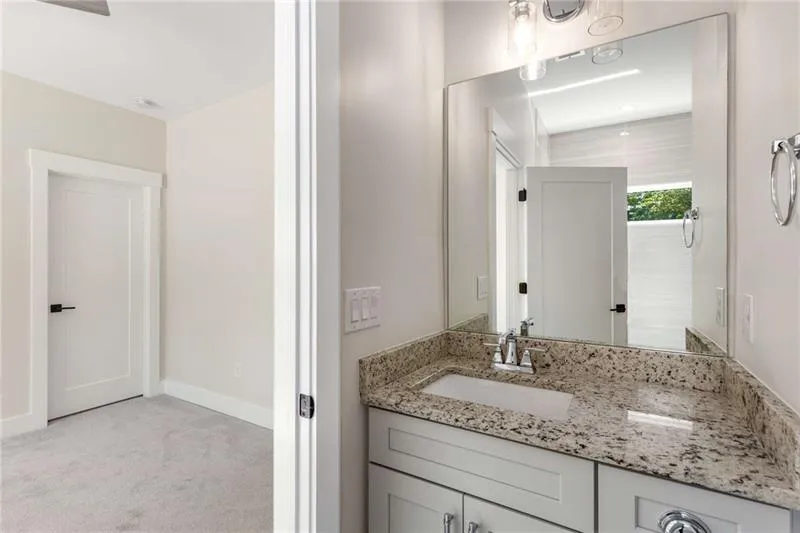 Bathroom featuring vanity and light colored carpet