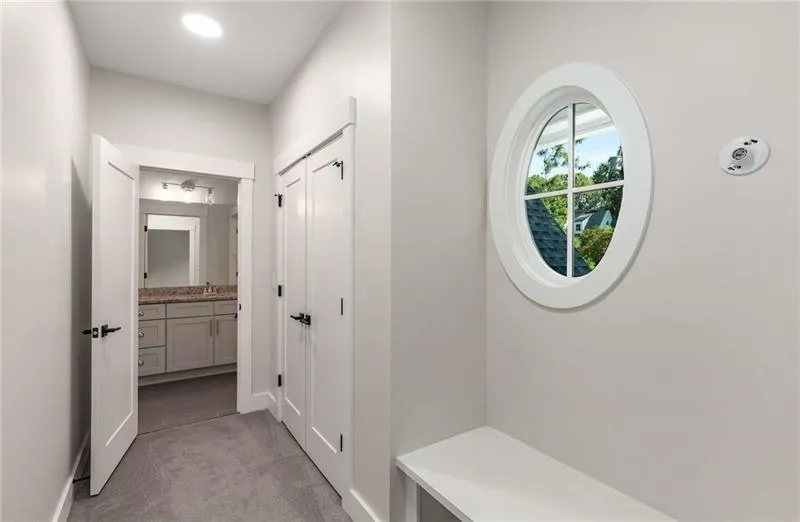 Mudroom with light carpet and baseboards