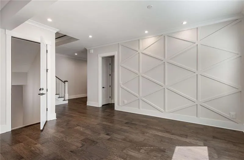 Spare room featuring stairs, dark wood finished floors, ornamental molding, and recessed lighting