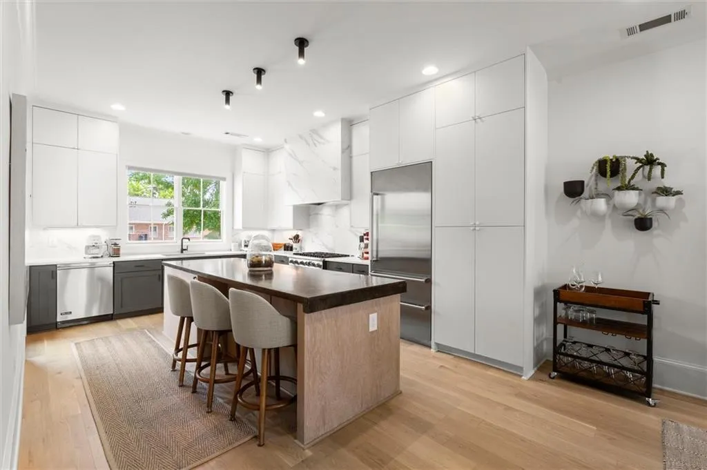 Chef's kitchen with concrete and quartz countertops.