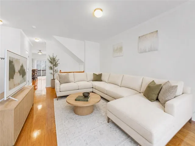 Primary listing photo has been virtually staged. The sofa was digitally replaced, and a coffee table and plant were digitally added. No permanent, structural, or architectural features were altered.