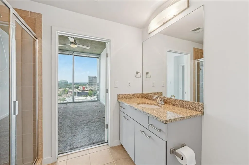 Full bath with vanity, tile flooring