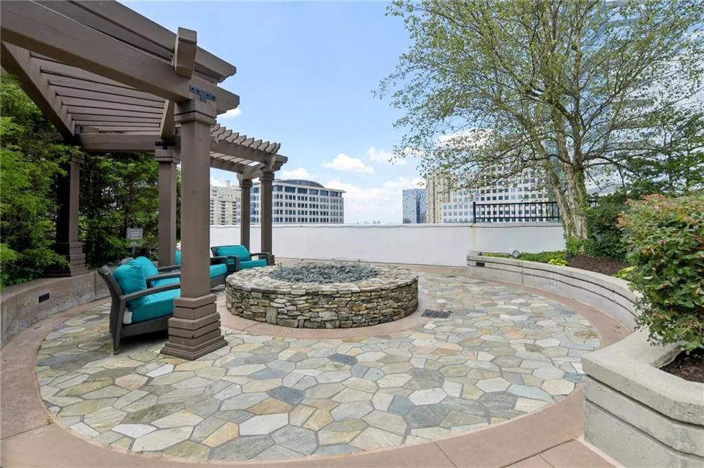 View of patio / terrace with an outdoor fire pit and a pergola