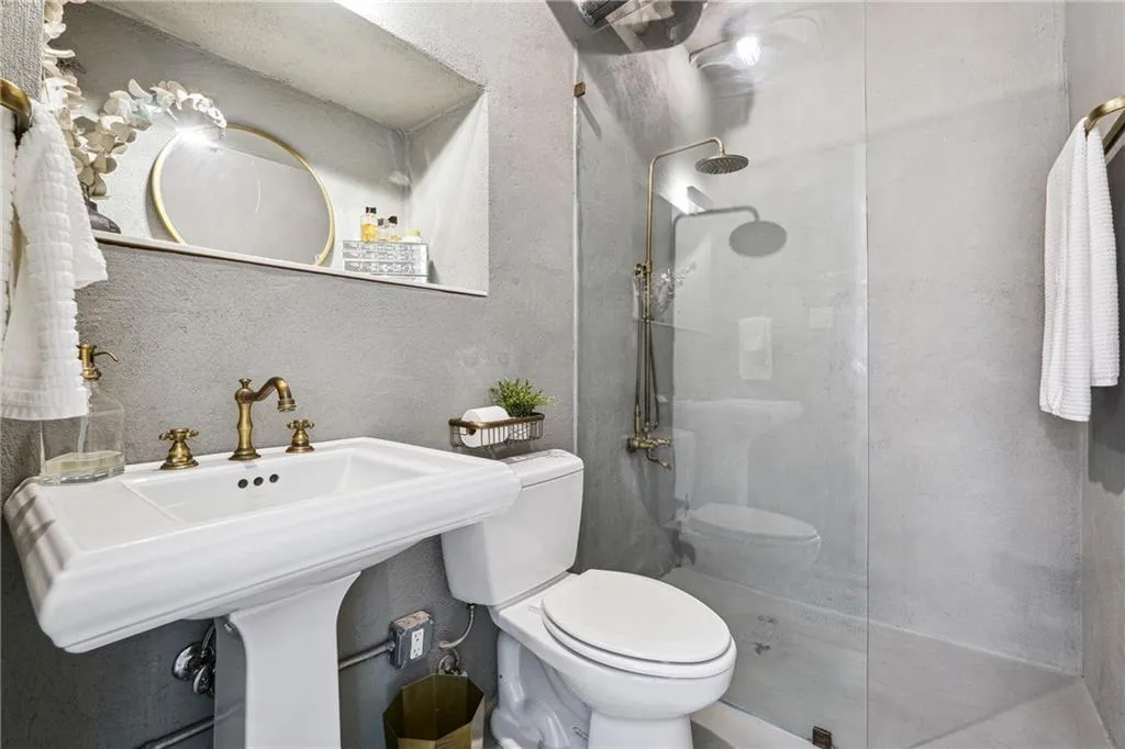 Full bathroom featuring a textured wall and a walk in shower