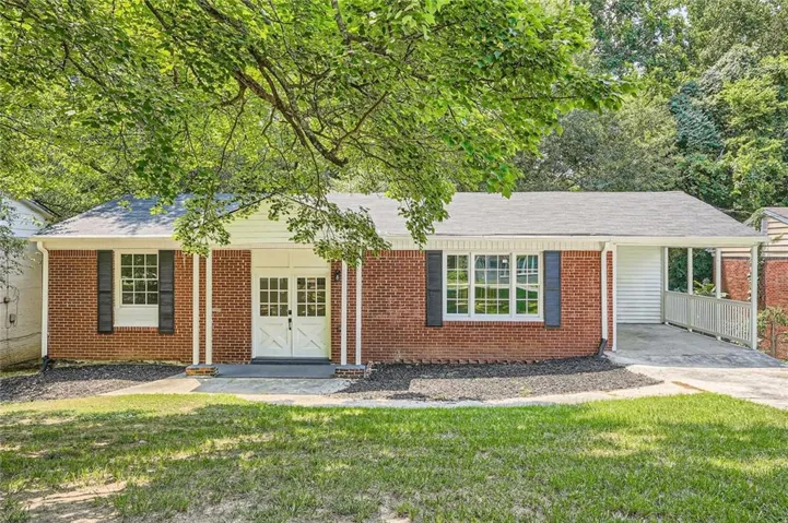 Brick exterior with white double entry doors