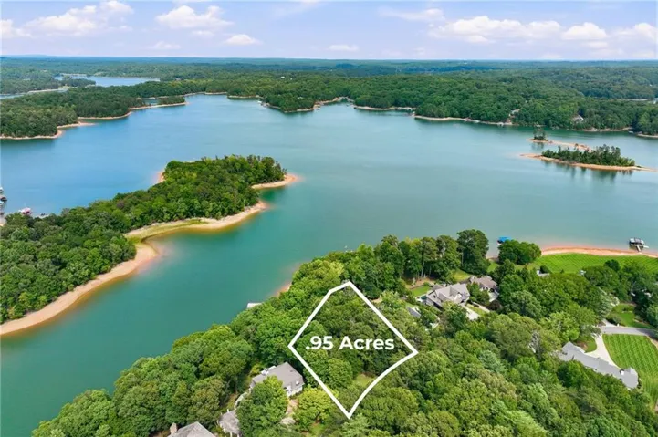 Expansive .95-acre parcel featuring significant tree coverage and direct waterfront access
